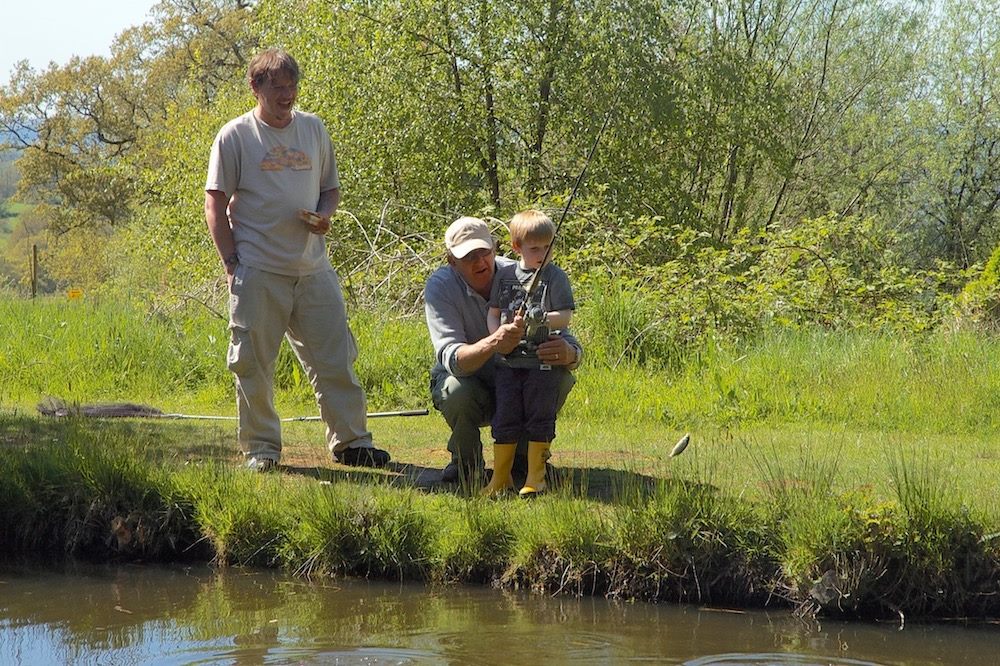 Three members of a family enjoying a fishing outing